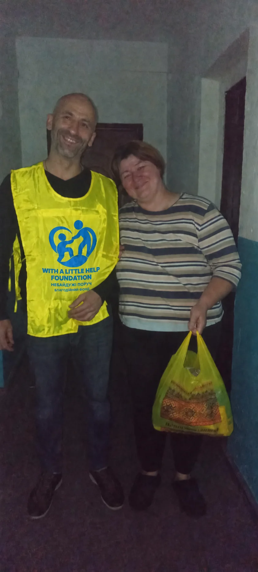 Another photograph of the team member and the woman in a striped top during the same visit.